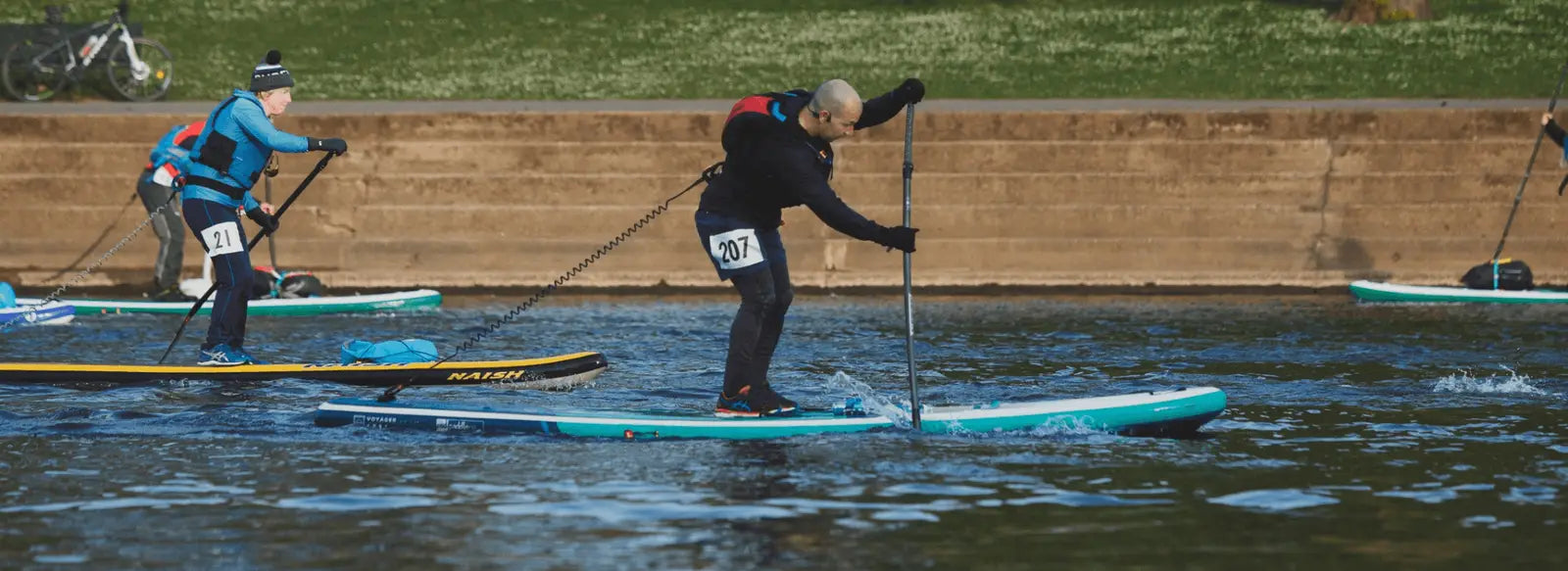 people racing on paddleboards