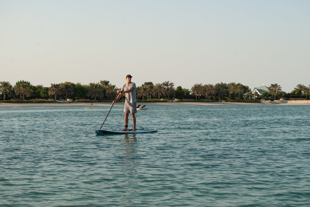 man on his paddleboard paddling on the ocean