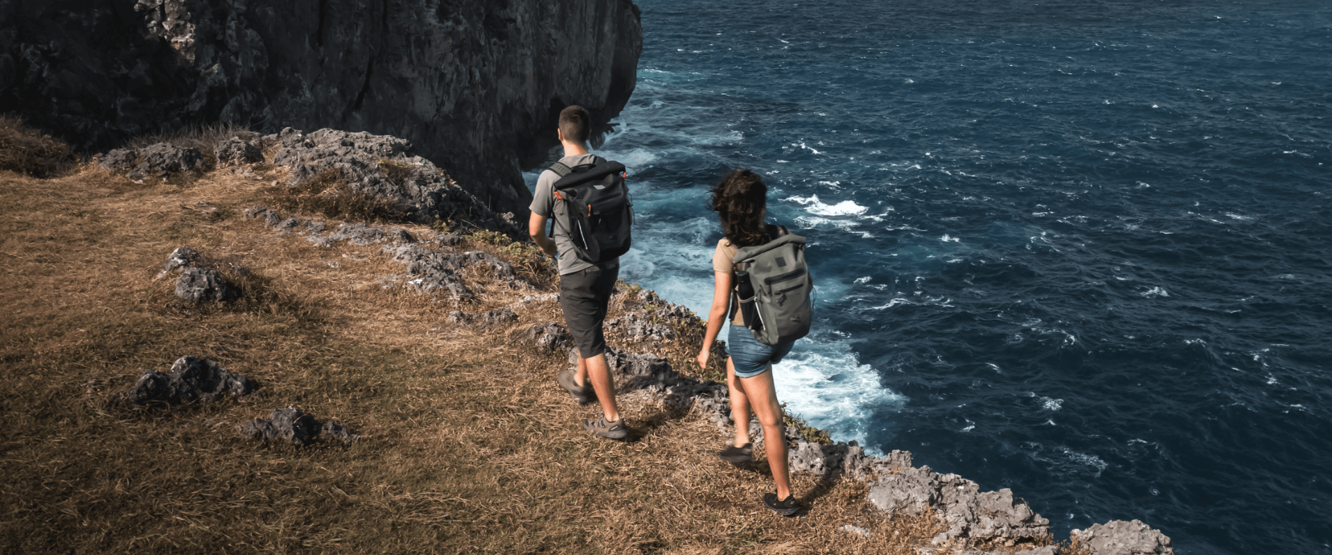 man and woman hiking with waterproof backpack