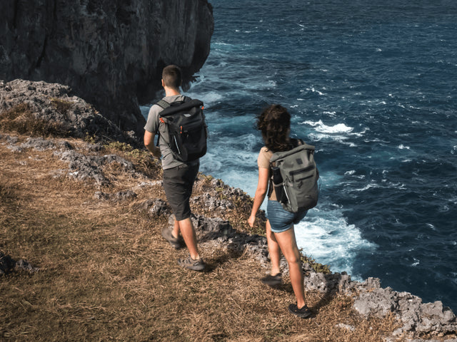 man and woman hiking with waterproof backpack