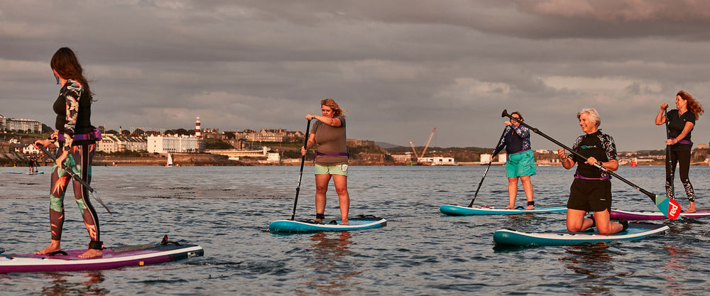 group of women paddleboarding