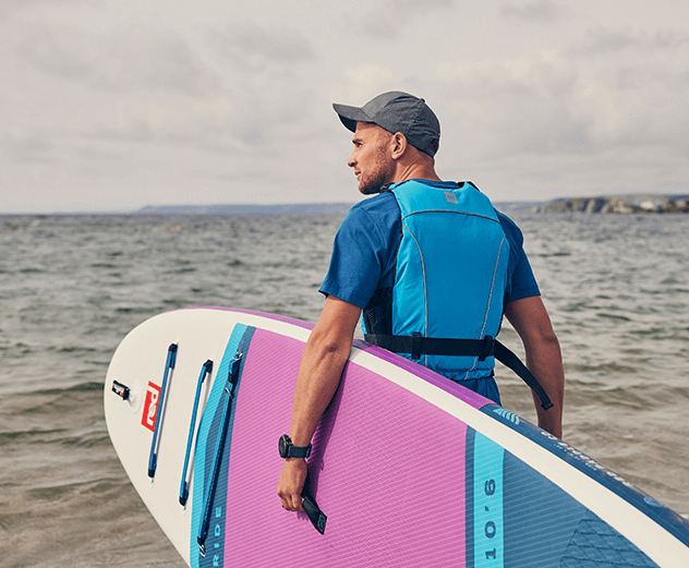 Man carrying Red Original Paddle Board