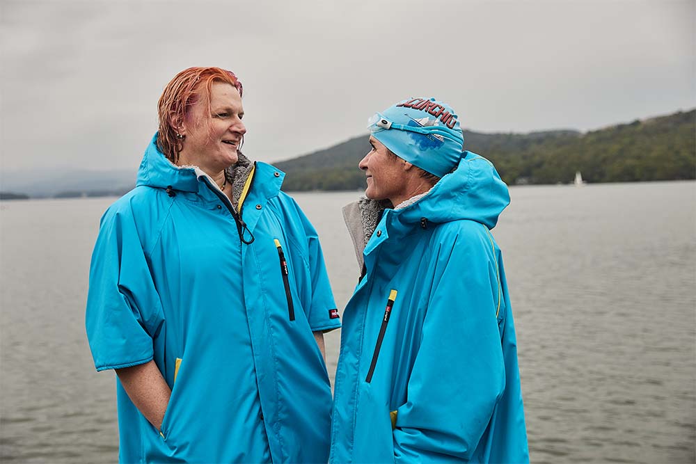 Two people wearing Red Original changing robes