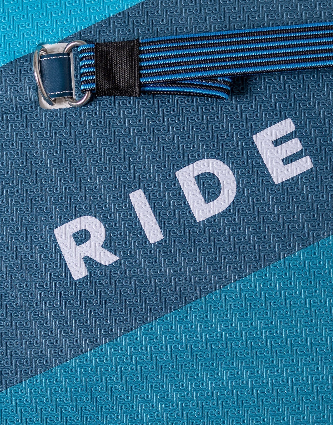 A zoomed in photo of a blue paddleboard with the word ride on the board